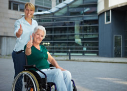 an elderly woman in a wheelchair and her companion